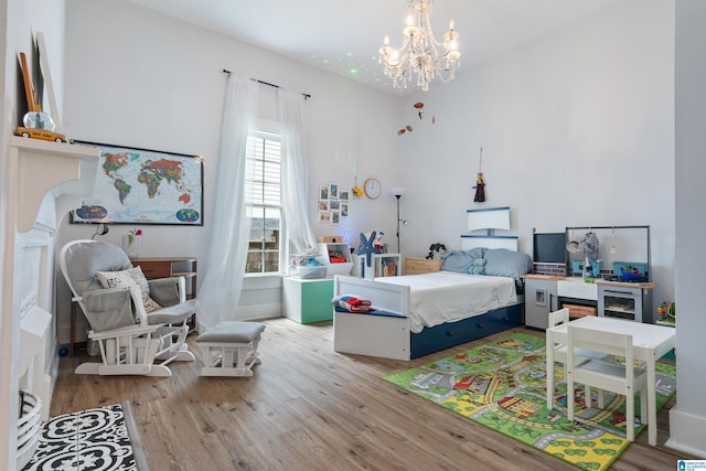 bedroom with an inviting chandelier and wood finished floors