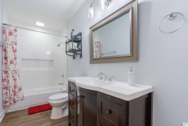 bathroom featuring toilet, shower / bath combo, wood finished floors, and vanity