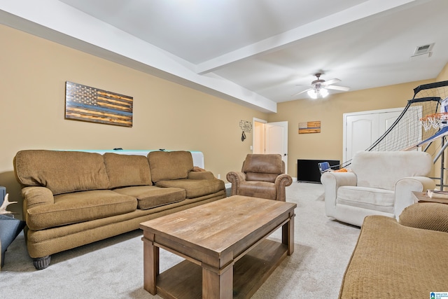 living room featuring ceiling fan, visible vents, beam ceiling, and light colored carpet