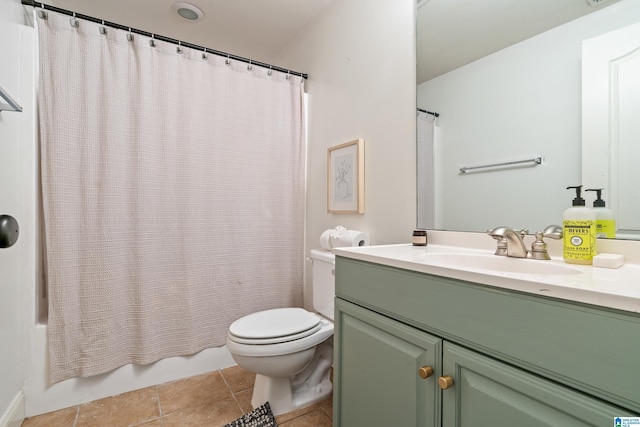 bathroom featuring toilet, shower / bath combo with shower curtain, vanity, and tile patterned floors