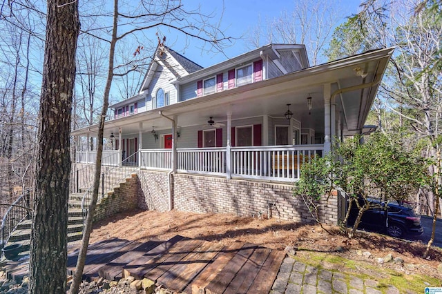 view of front facade with covered porch, stairway, and a ceiling fan