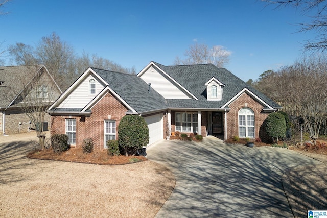 view of front facade with driveway, brick siding, an attached garage, and a shingled roof