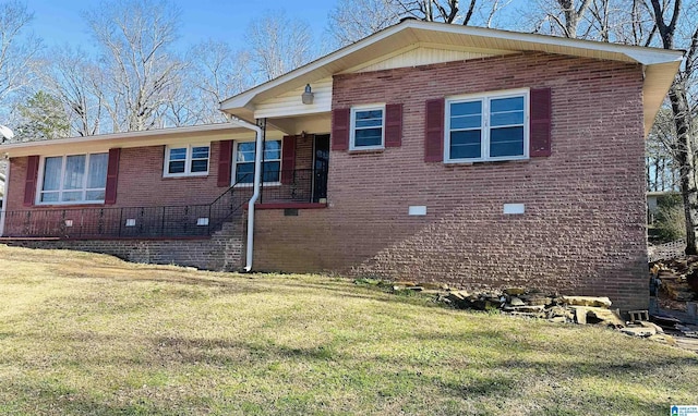 view of front of home with brick siding and a front lawn