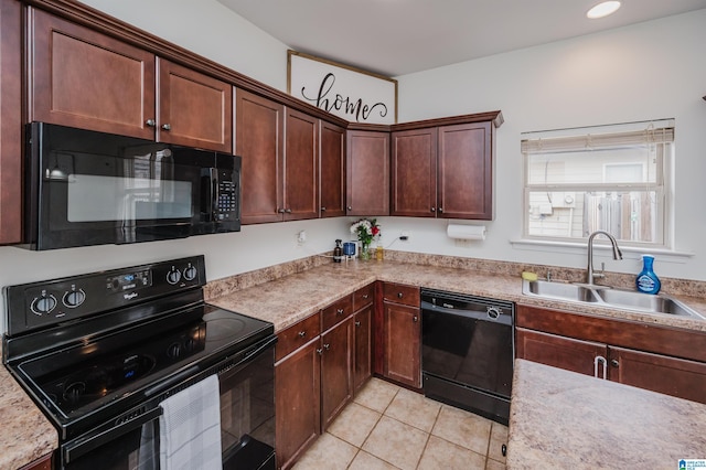 kitchen with light tile patterned floors, recessed lighting, a sink, dark brown cabinets, and black appliances