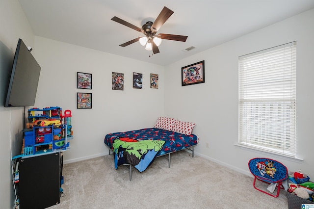 bedroom featuring light carpet, baseboards, visible vents, and ceiling fan