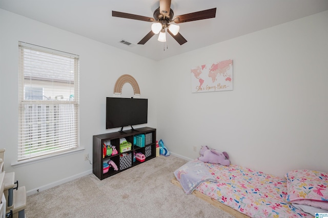 bedroom featuring light carpet, baseboards, visible vents, and ceiling fan