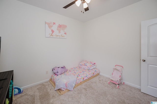 carpeted bedroom with ceiling fan and baseboards