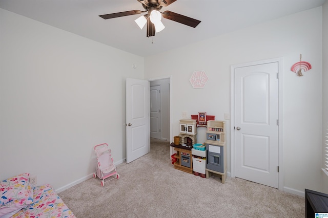 bedroom with a ceiling fan, light colored carpet, and baseboards