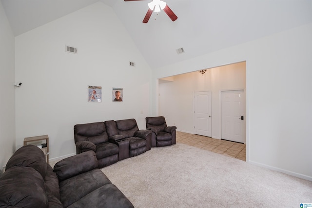 living area with high vaulted ceiling, light colored carpet, visible vents, and baseboards