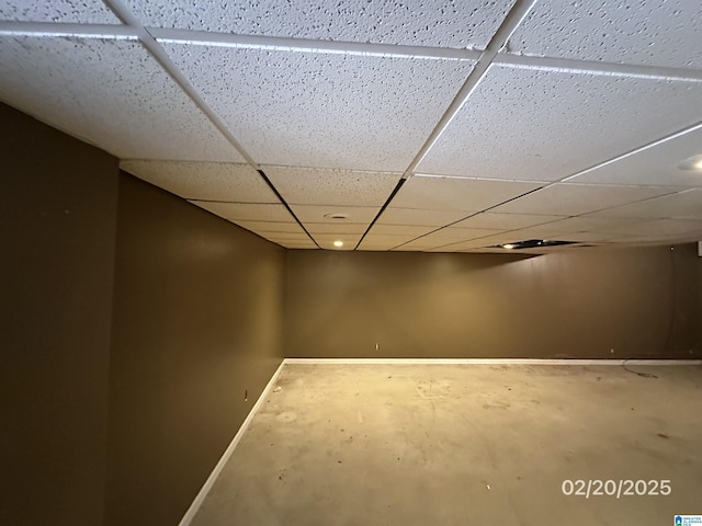 finished basement with a drop ceiling and baseboards