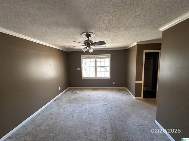 carpeted empty room featuring baseboards, ornamental molding, ceiling fan, and a textured ceiling