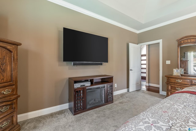 bedroom with light carpet, crown molding, and baseboards