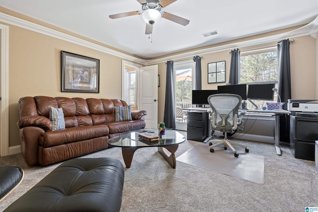 office area with light carpet, crown molding, visible vents, and ceiling fan