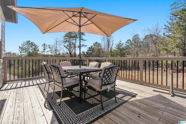 wooden deck featuring outdoor dining space