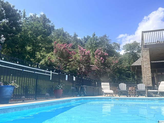 view of swimming pool with fence and a fenced in pool