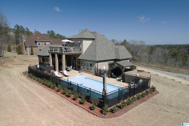 view of swimming pool featuring a patio area, fence, and a fenced in pool