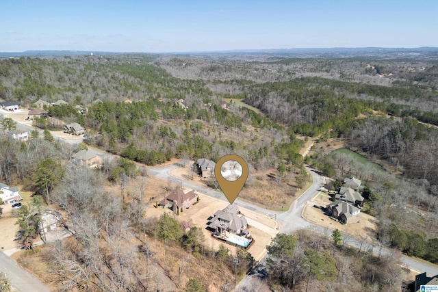 aerial view featuring a wooded view