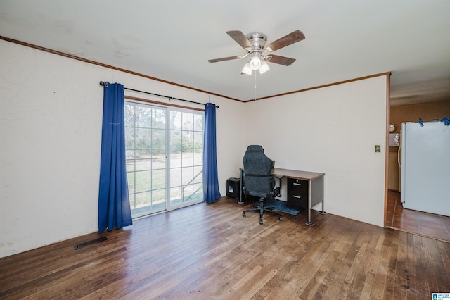 home office featuring a textured wall, visible vents, a ceiling fan, ornamental molding, and hardwood / wood-style floors