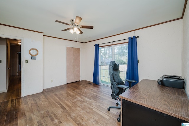 office space featuring ceiling fan, ornamental molding, wood finished floors, and a textured wall