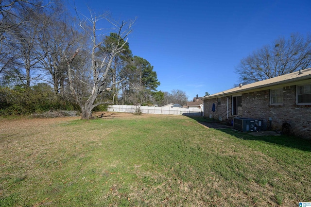 view of yard featuring cooling unit and fence