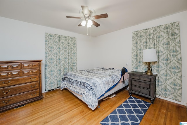 bedroom featuring a ceiling fan and wood finished floors