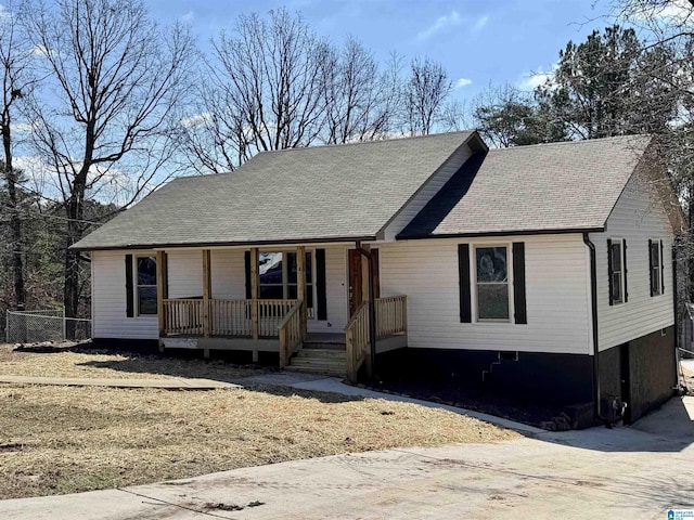 view of front of property with a porch and roof with shingles