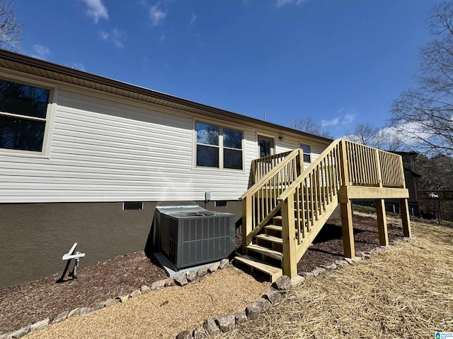 back of property with central AC, stairway, crawl space, and a wooden deck