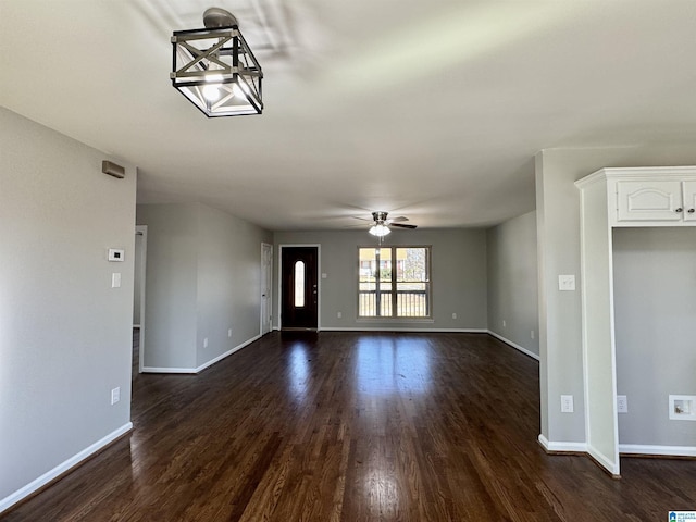 entryway with dark wood-style flooring, ceiling fan, and baseboards