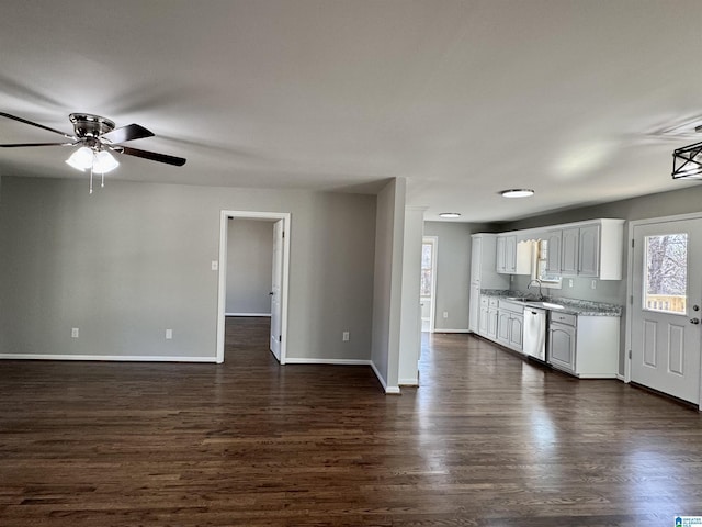 kitchen featuring baseboards, white cabinetry, dark wood finished floors, and a sink