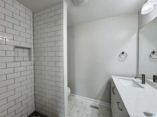 full bath with a stall shower, baseboards, visible vents, marble finish floor, and vanity