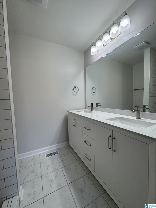 full bathroom featuring marble finish floor, visible vents, a sink, and baseboards