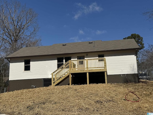 rear view of property with stairway and a wooden deck