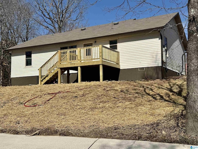 rear view of house featuring stairs and a deck