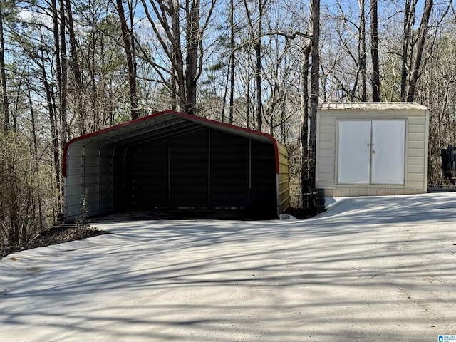 garage with a detached carport and driveway