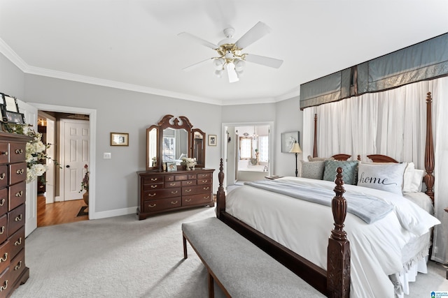 bedroom featuring light carpet, baseboards, ceiling fan, ornamental molding, and ensuite bathroom