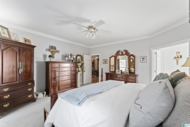 bedroom featuring ceiling fan, a walk in closet, crown molding, and light colored carpet