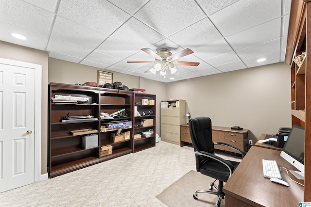 office featuring ceiling fan, a drop ceiling, and carpet flooring