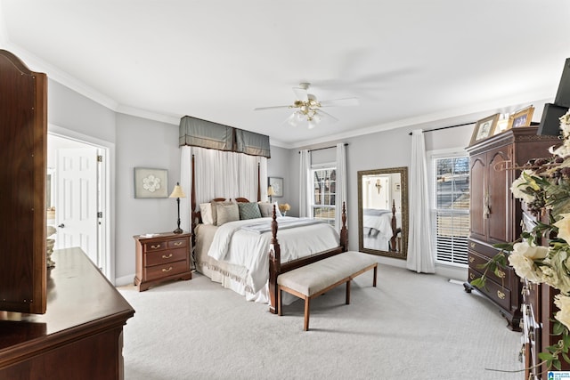 bedroom featuring ceiling fan, ornamental molding, and light colored carpet