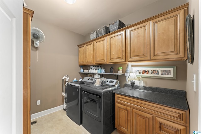 laundry room featuring visible vents, cabinet space, washer and clothes dryer, and baseboards