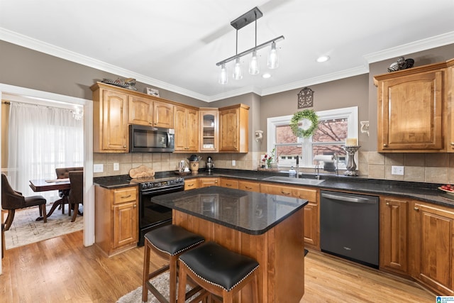 kitchen featuring hanging light fixtures, stainless steel dishwasher, a center island, black electric range oven, and glass insert cabinets