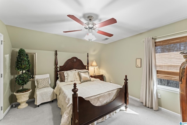 bedroom featuring a ceiling fan, lofted ceiling, light colored carpet, and baseboards