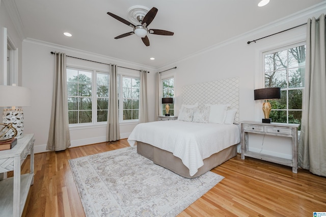 bedroom with recessed lighting, ornamental molding, ceiling fan, wood finished floors, and baseboards