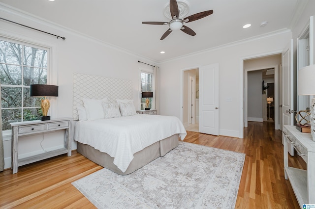 bedroom with recessed lighting, baseboards, crown molding, and wood finished floors