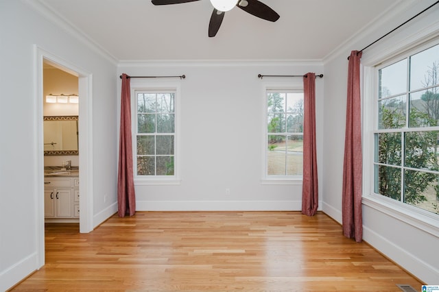 unfurnished bedroom featuring light wood-type flooring, crown molding, and baseboards