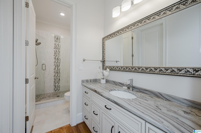 full bath with toilet, a stall shower, and vanity