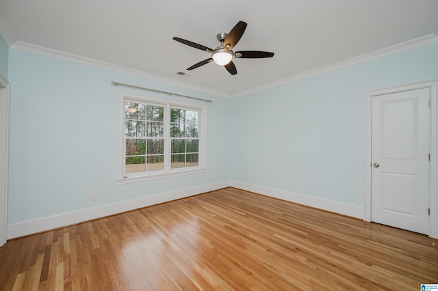 unfurnished room featuring ornamental molding, ceiling fan, light wood-style flooring, and baseboards