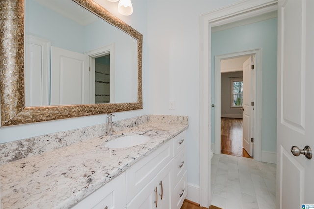 bathroom featuring vanity and baseboards