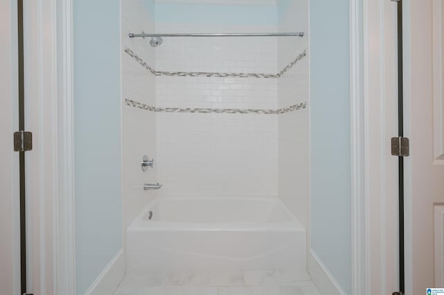 full bath featuring bathtub / shower combination and baseboards