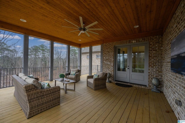 sunroom / solarium with french doors, plenty of natural light, wood ceiling, and a ceiling fan