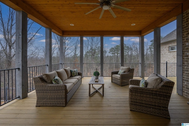 sunroom / solarium with wooden ceiling, a wealth of natural light, and a ceiling fan